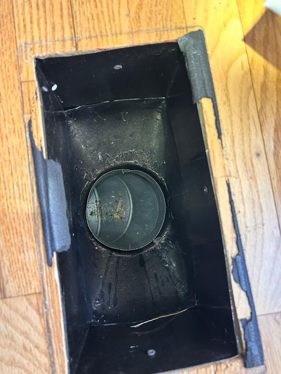 Floor vent boot with dust and debris before air duct cleaning